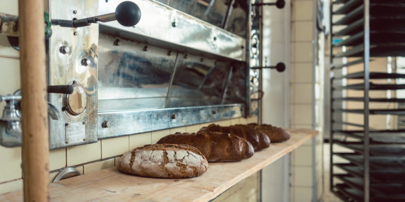 Loafs of bread waiting on shelf in bakery to be sold Industrial System Integration